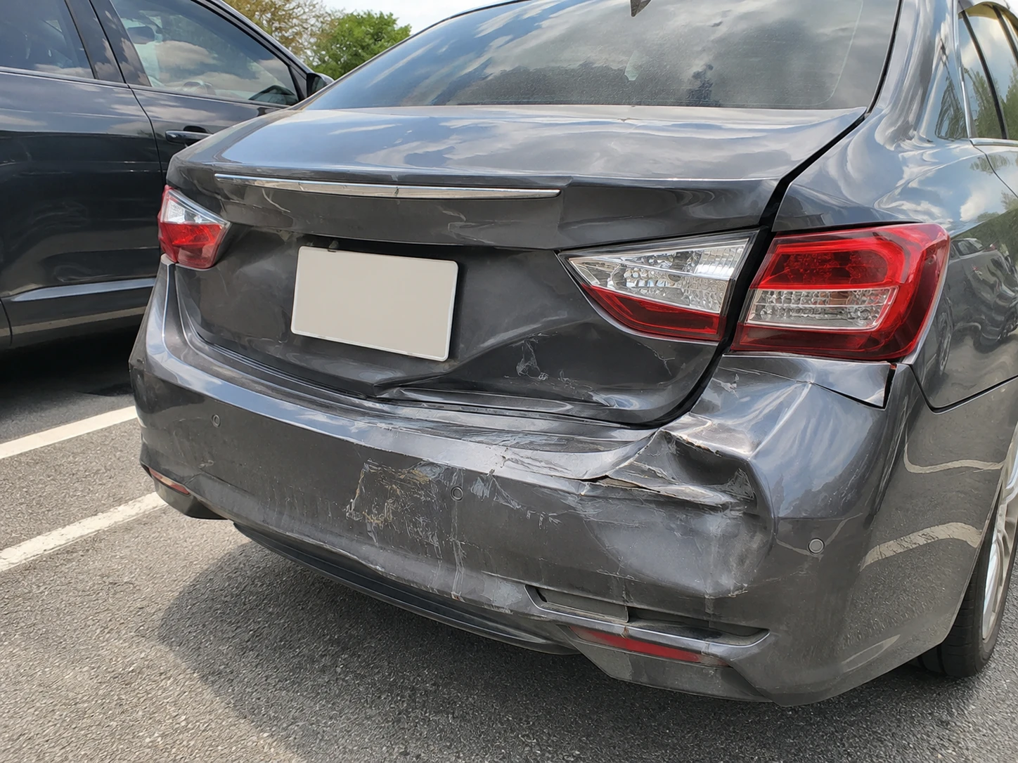 Photo sent: the dented rear bumper and trunk