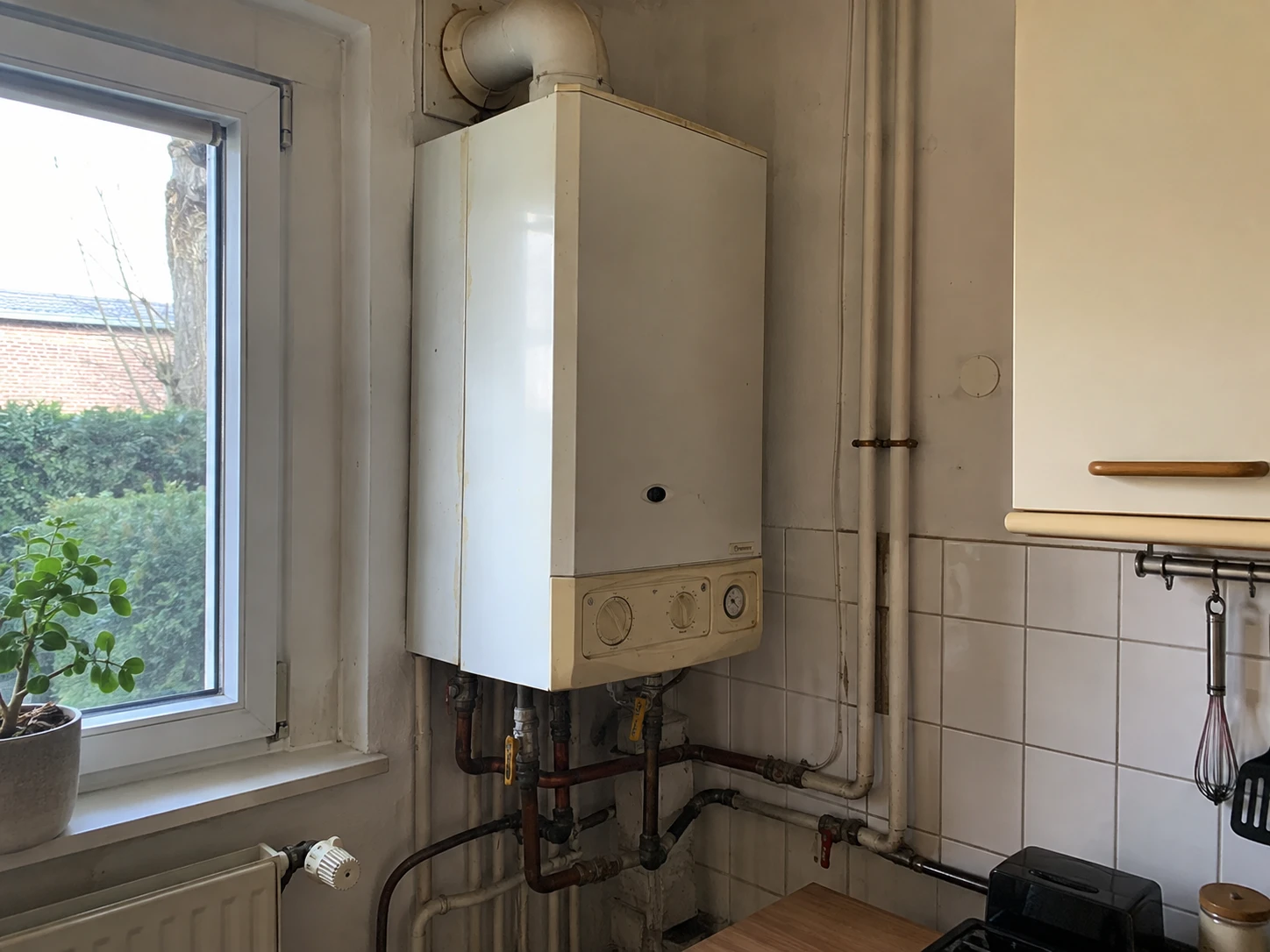 Photo sent: an old wall-mounted boiler in a kitchen